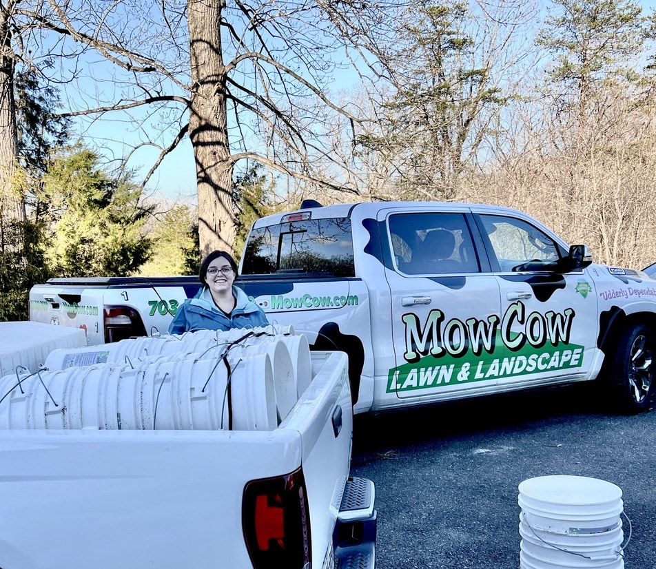 NVSWCD Education Specialist Ashley Palmer loads 5-gallon buckets donated by MowCow into truck