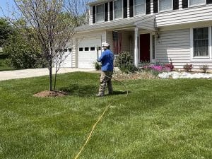 Tech spraying GrowCow lawn nutrition